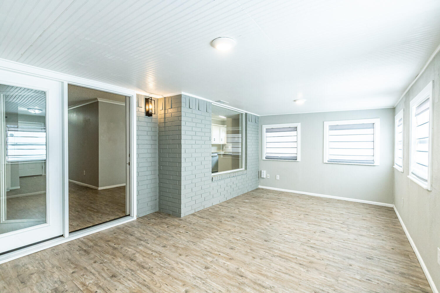 9611 Bangor Avenue Lubbock, TX 79424 - Photo 13 of 29 wooden floor in an empty room with a window