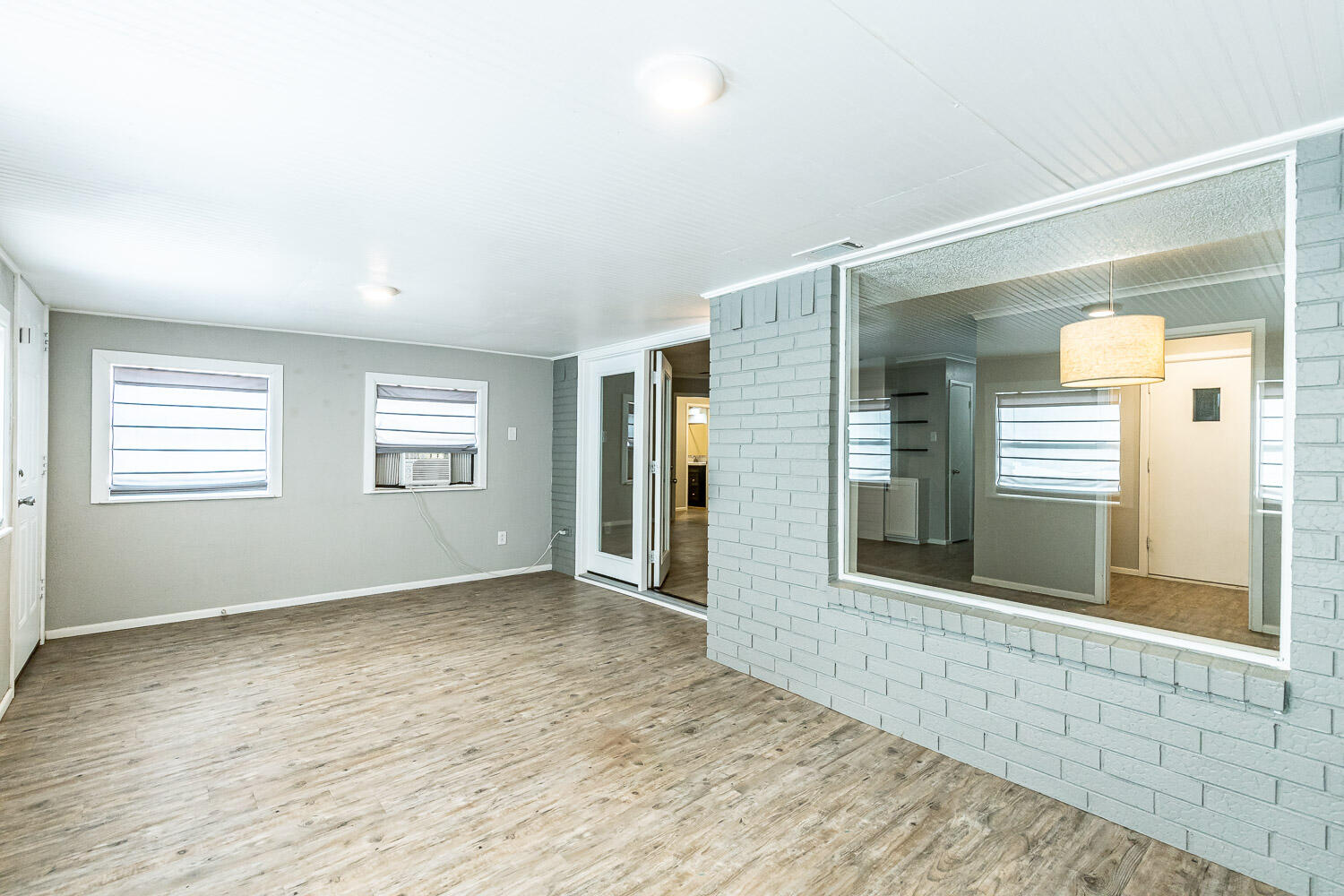 9611 Bangor Avenue Lubbock, TX 79424 - Photo 14 of 29 a view of an empty room with wooden floor and a window
