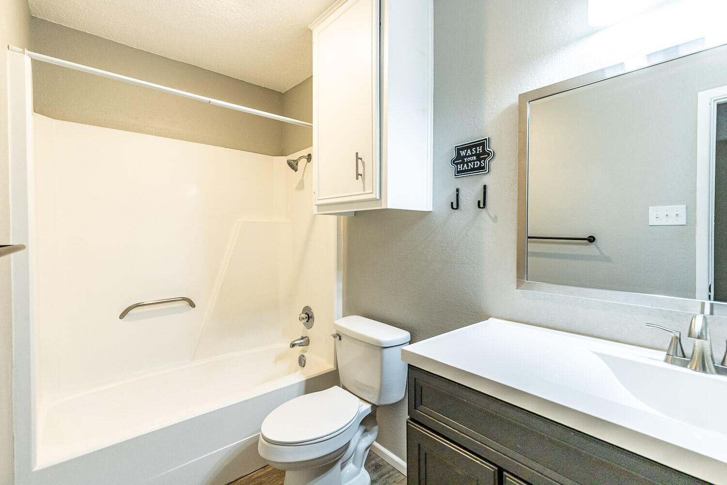 9611 Bangor Avenue Lubbock, TX 79424 - Photo 19 of 29 a bathroom with a sink a toilet and shower