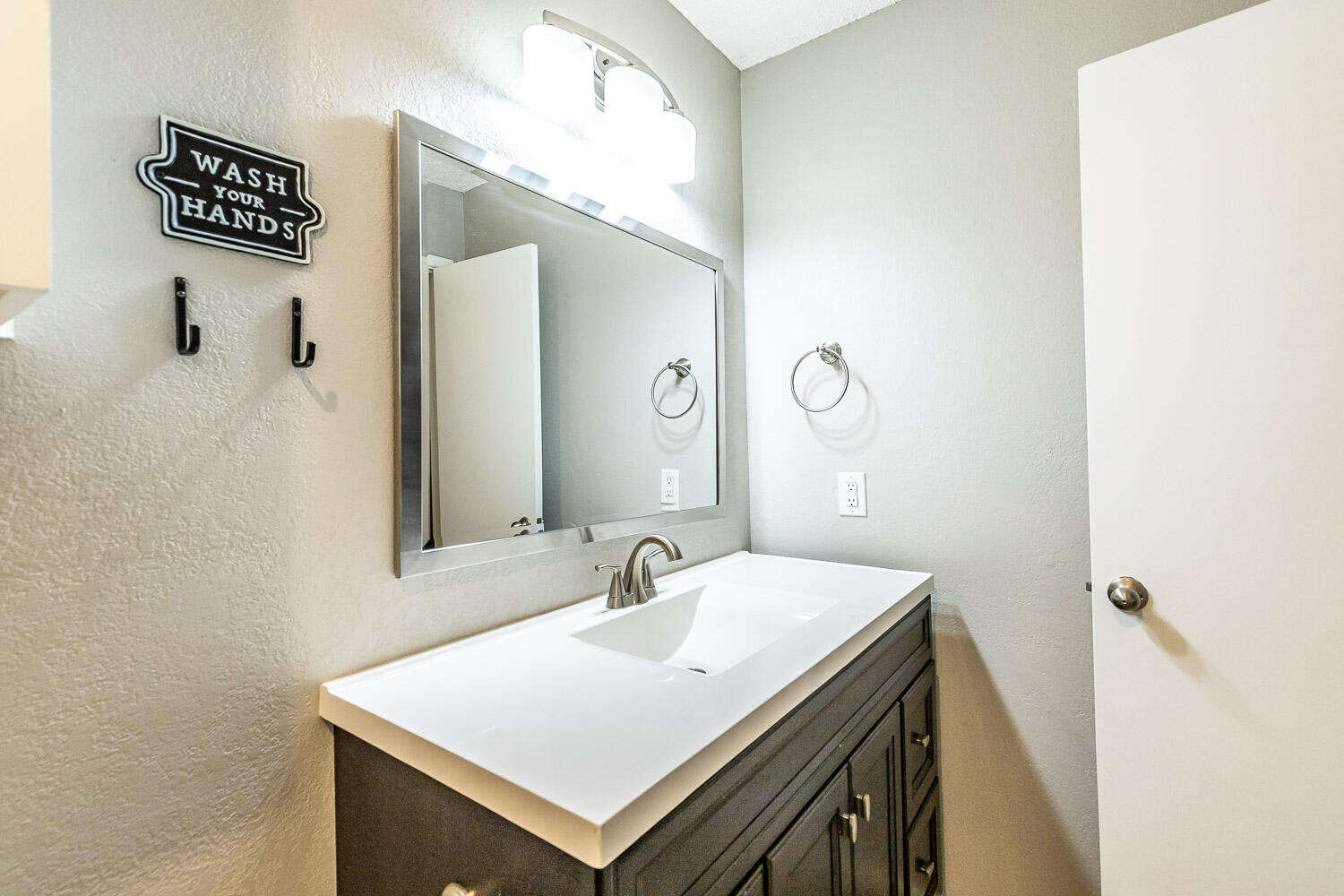 9611 Bangor Avenue Lubbock, TX 79424 - Photo 20 of 29 a bathroom with a sink and a mirror