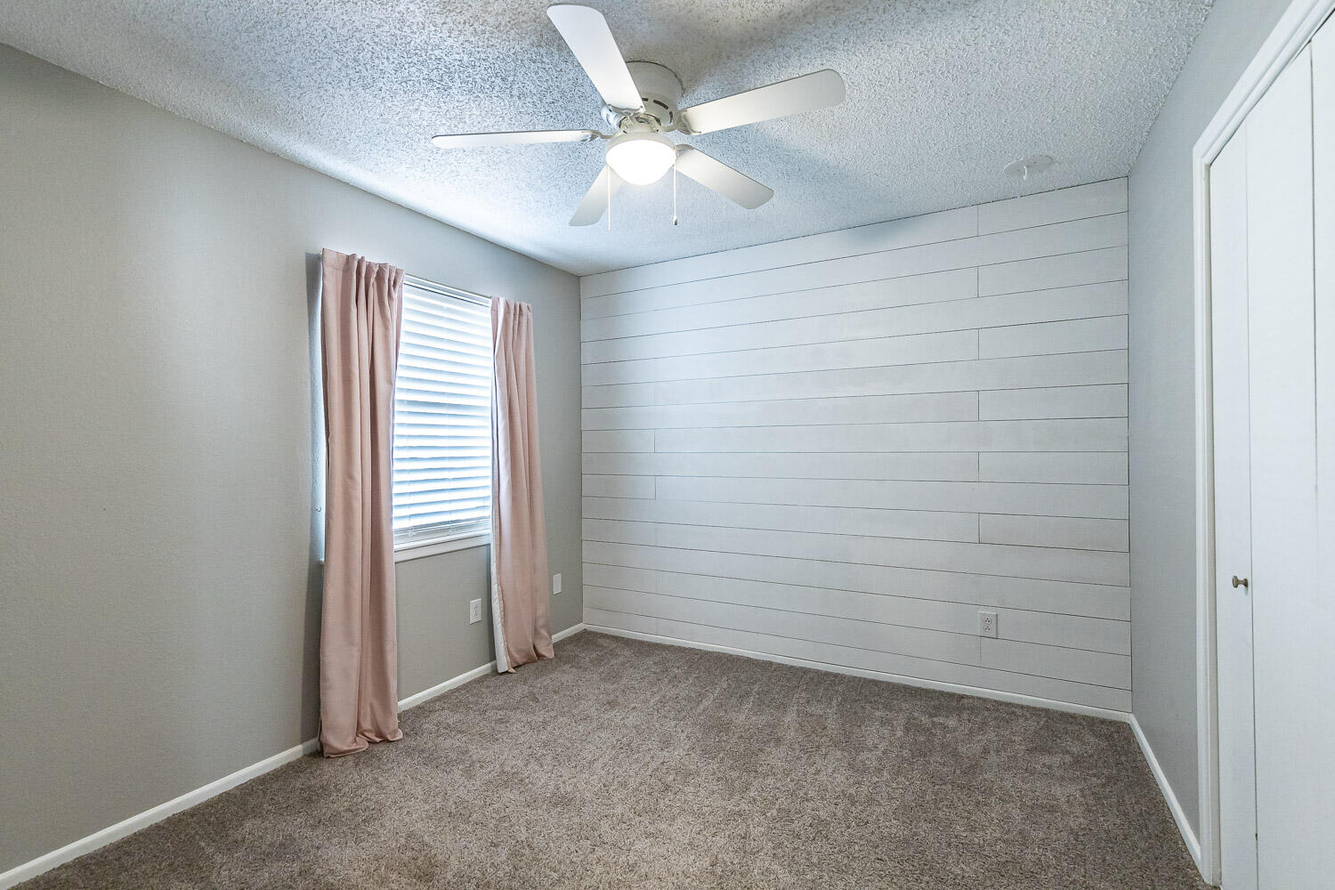 9611 Bangor Avenue Lubbock, TX 79424 - Photo 21 of 29 an empty room with a ceiling fan and closet