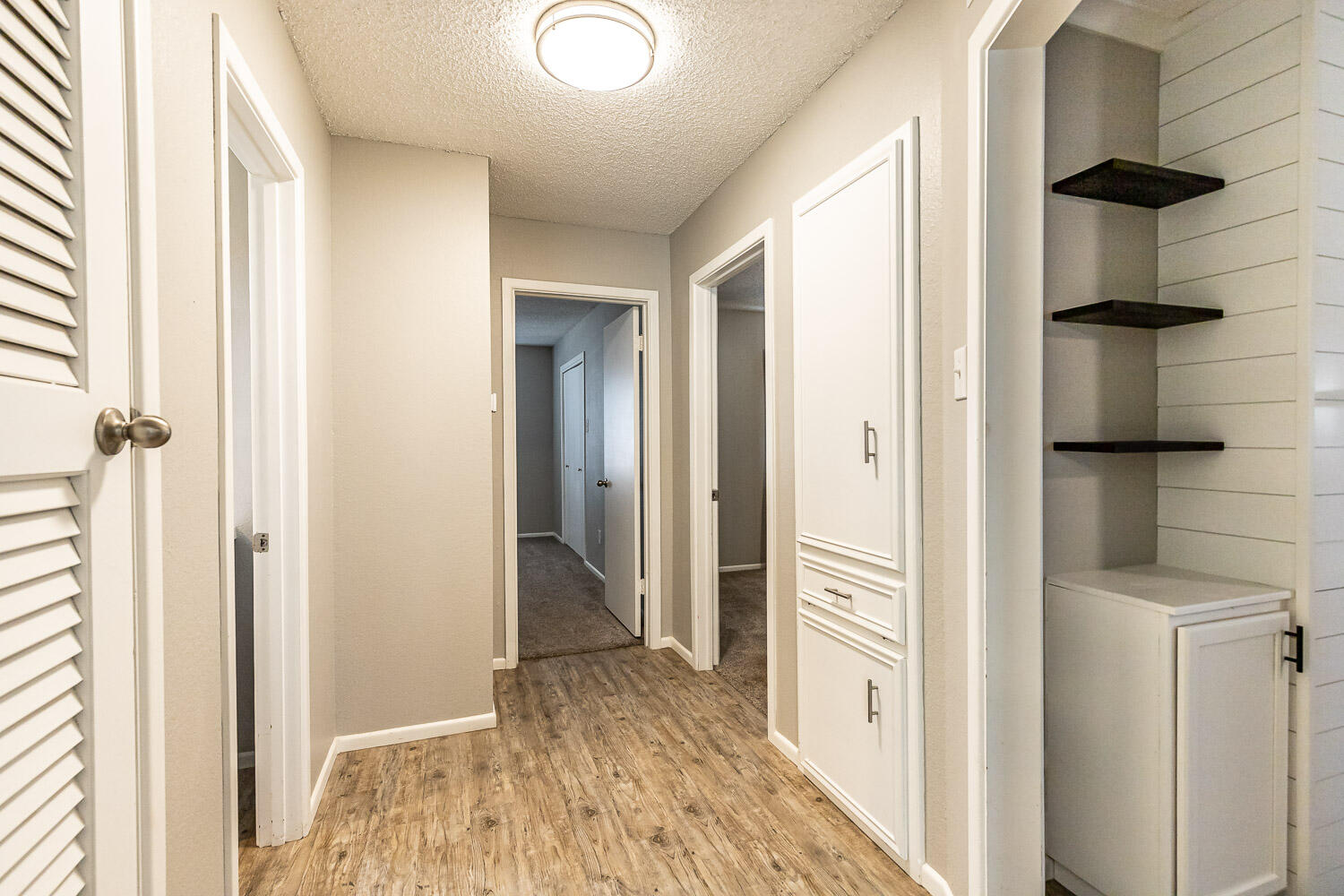 9611 Bangor Avenue Lubbock, TX 79424 - Photo 22 of 29 a view of a hallway with wooden floor and staircase