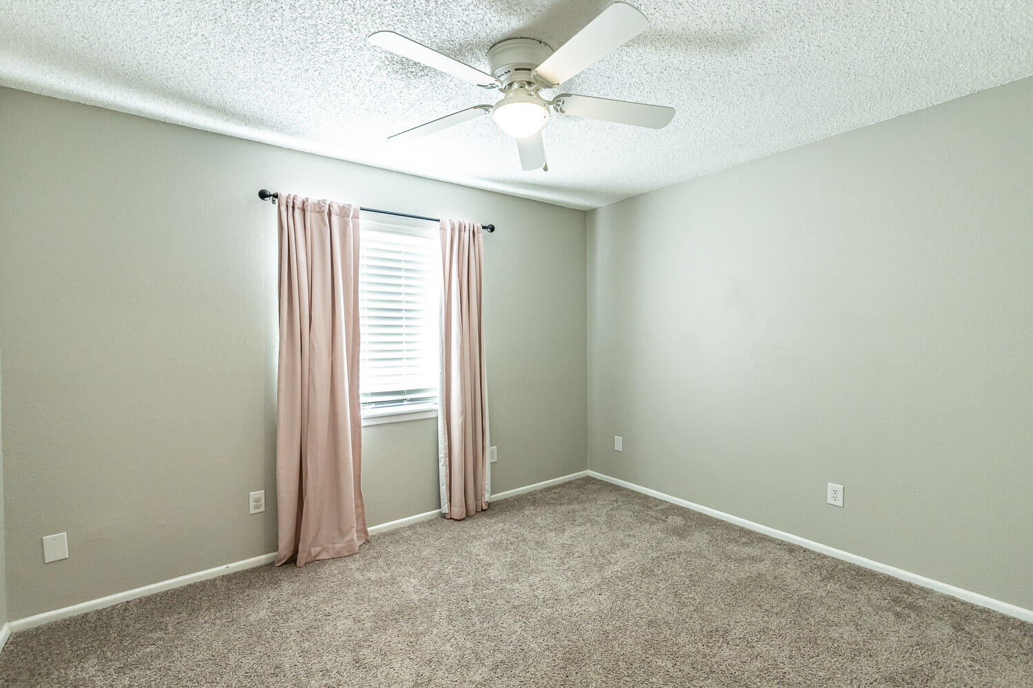 9611 Bangor Avenue Lubbock, TX 79424 - Photo 25 of 29 an empty room with windows and fan