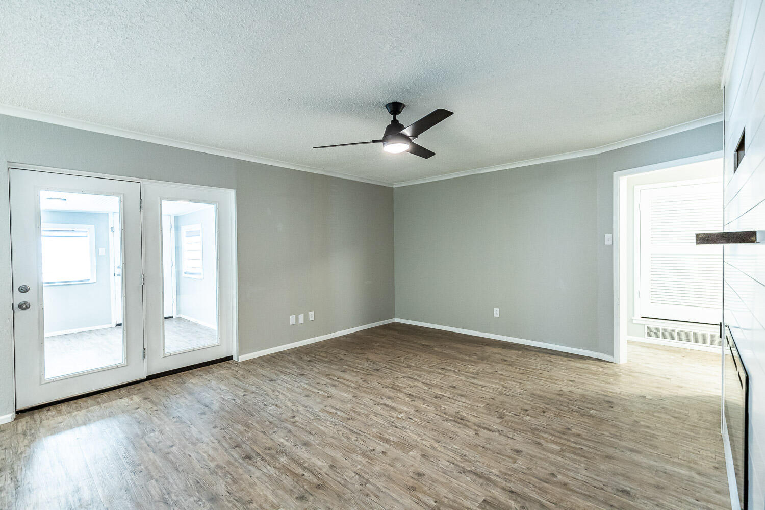 9611 Bangor Avenue Lubbock, TX 79424 - Photo 4 of 29 wooden floor in an empty room with a window