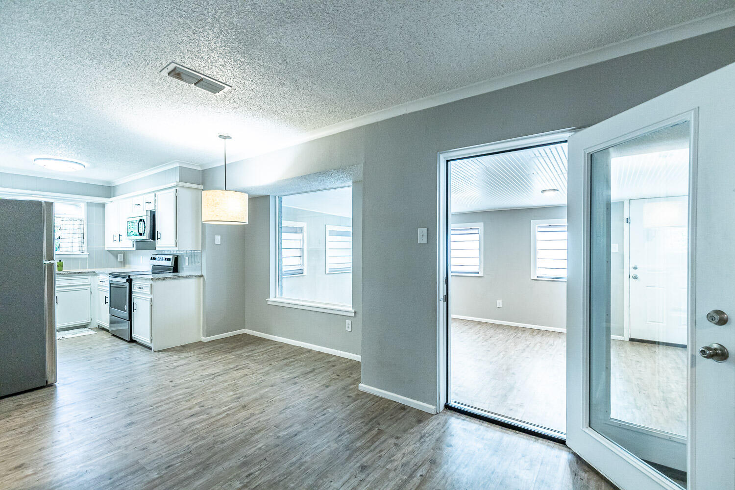 9611 Bangor Avenue Lubbock, TX 79424 - Photo 6 of 29 a view of a kitchen with refrigerator and wooden floor