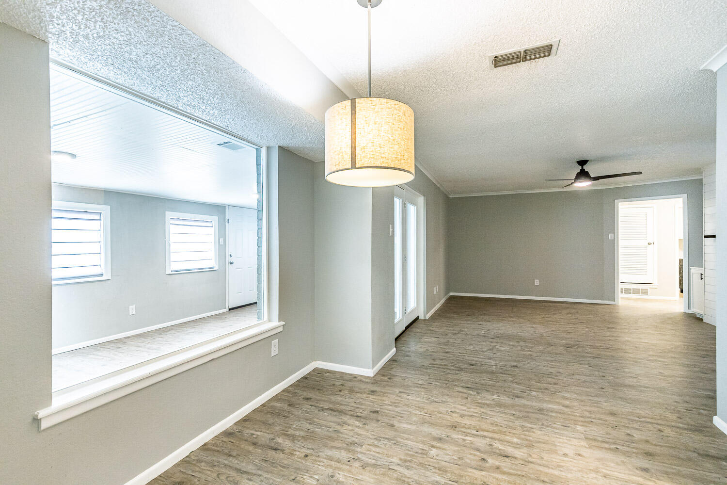 9611 Bangor Avenue Lubbock, TX 79424 - Photo 10 of 29 a view of a room with wooden floor and windows