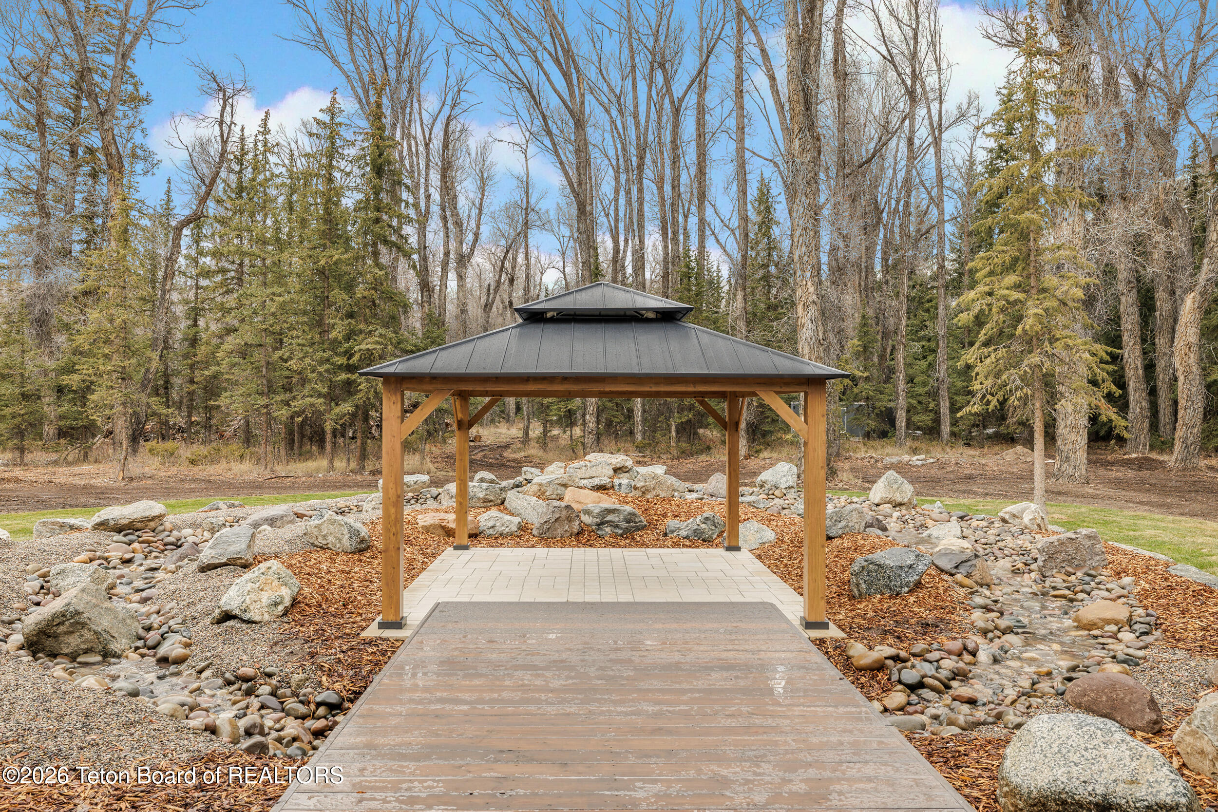 8910 Porter Loop Road Jackson, WY 83001 - Photo 23 of 79 Dining Pavillion in a double water fall