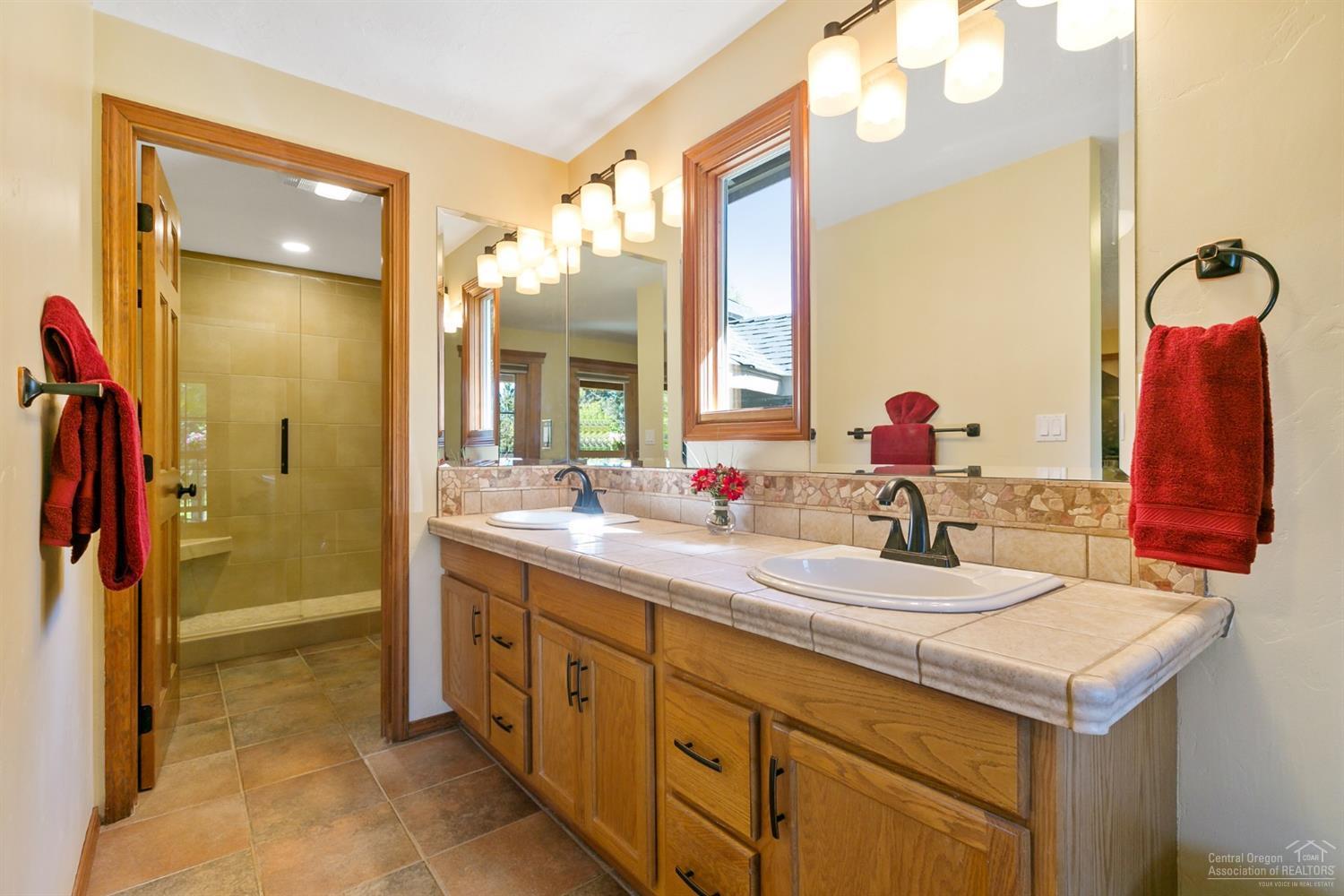 21210 Yeoman Road Bend, OR 97701 - Photo 14 of 25 a bathroom with a sink vanity and a mirror