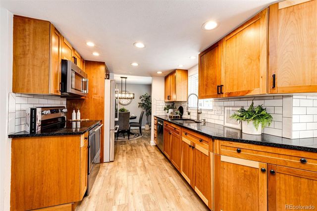 a kitchen with stainless steel appliances a sink and counter space