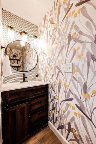 a bathroom with a sink a mirror and vanity