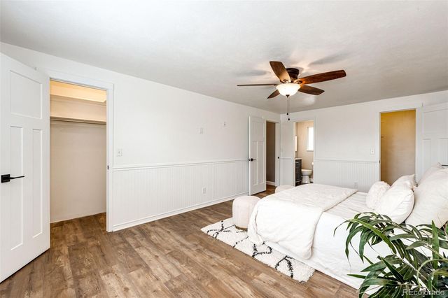 a bedroom with a bed and a ceiling fan
