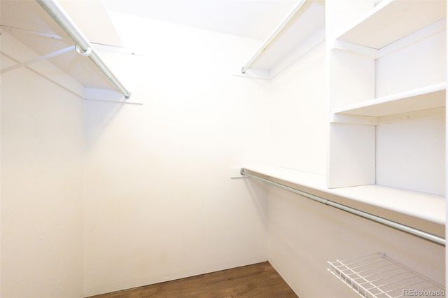 a bathroom with a granite countertop sink toilet and mirror