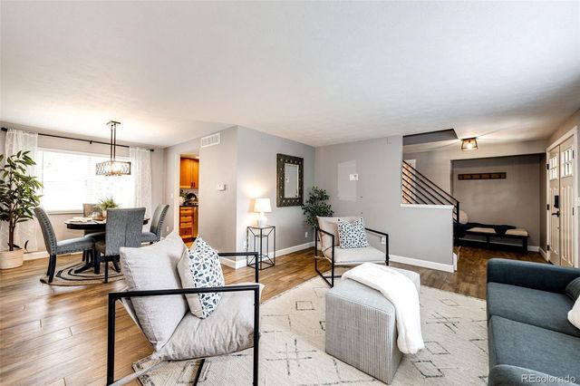 a living room with furniture and wooden floor
