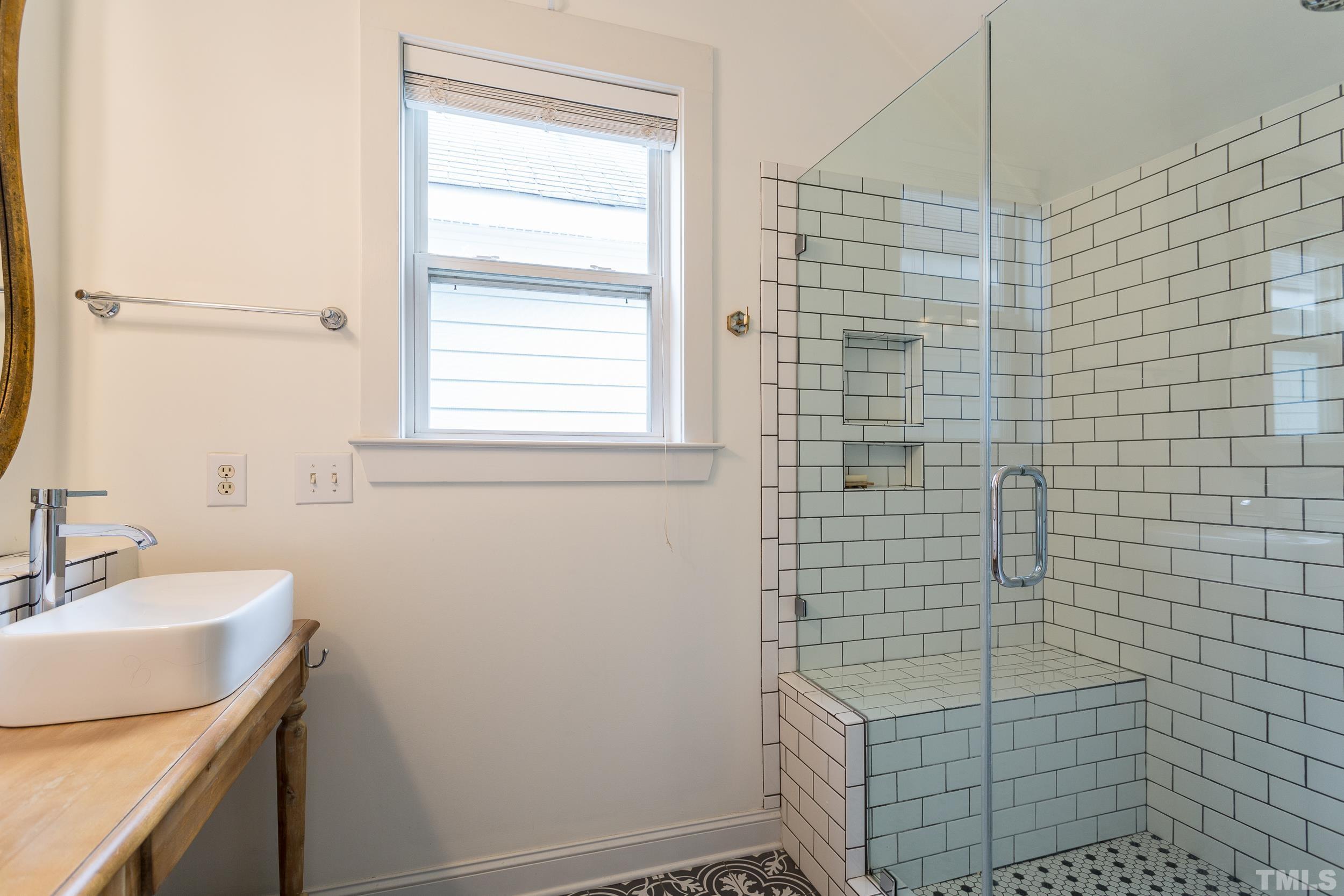 2116 Dunn Road Raleigh, NC 27614 - Photo 18 of 26 a bathroom with a sink a window and shower