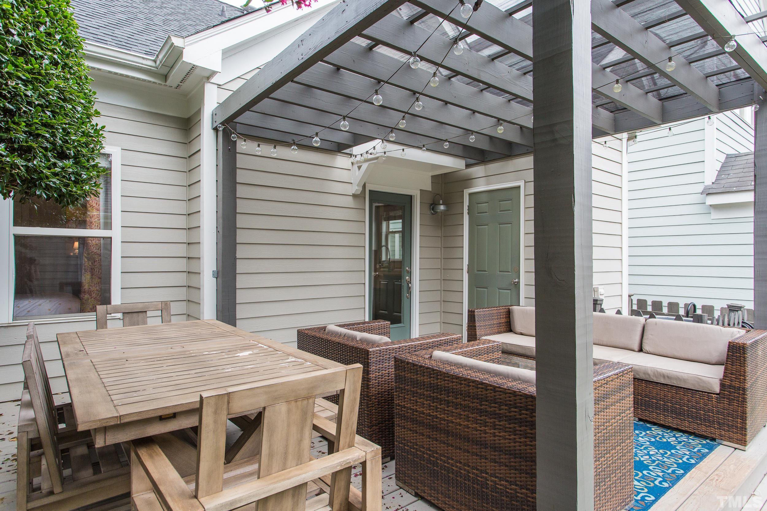 2116 Dunn Road Raleigh, NC 27614 - Photo 22 of 26 a view of a patio with table and chairs with wooden floor and fence