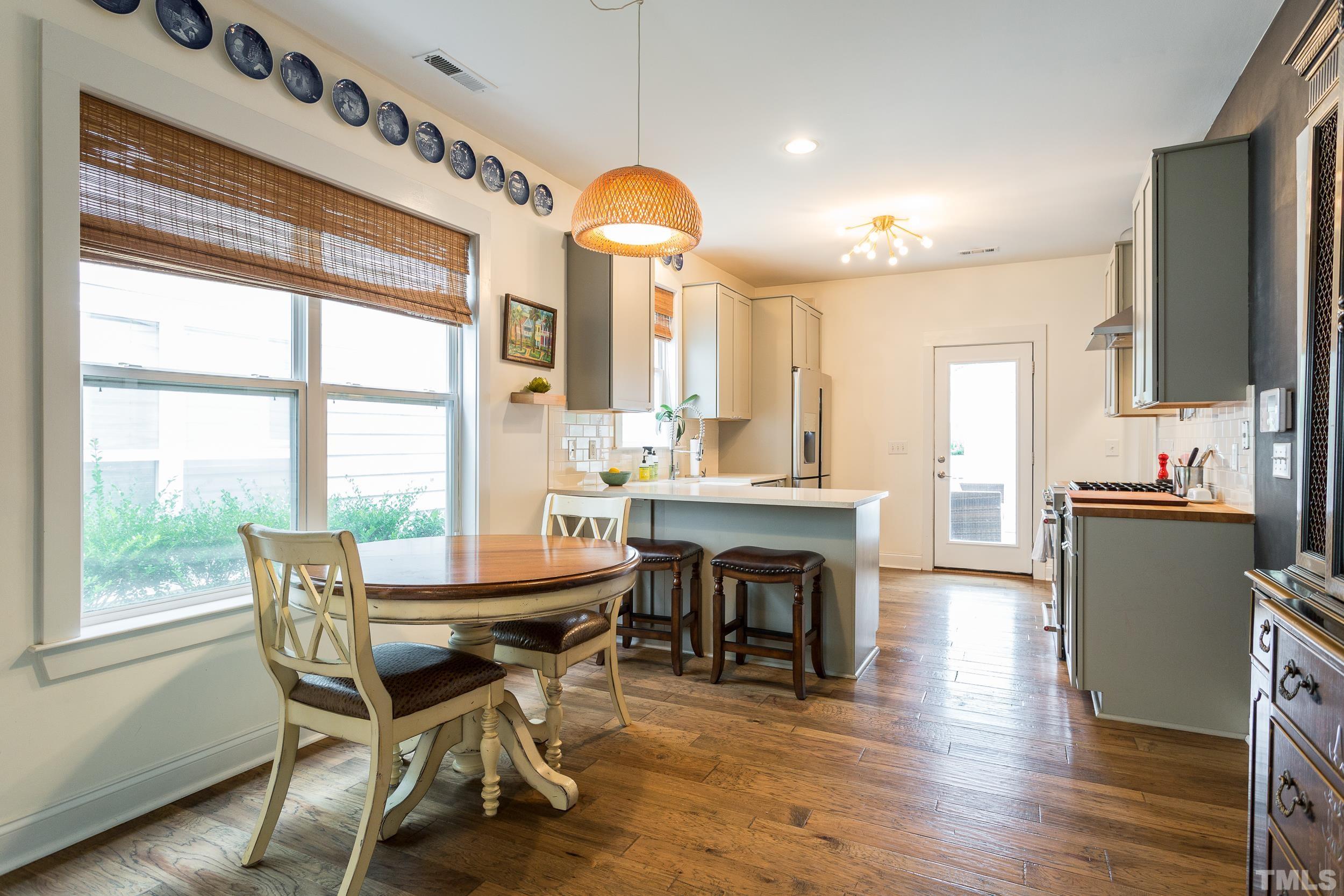 2116 Dunn Road Raleigh, NC 27614 - Photo 8 of 26 a dining room with furniture a fireplace and wooden floor