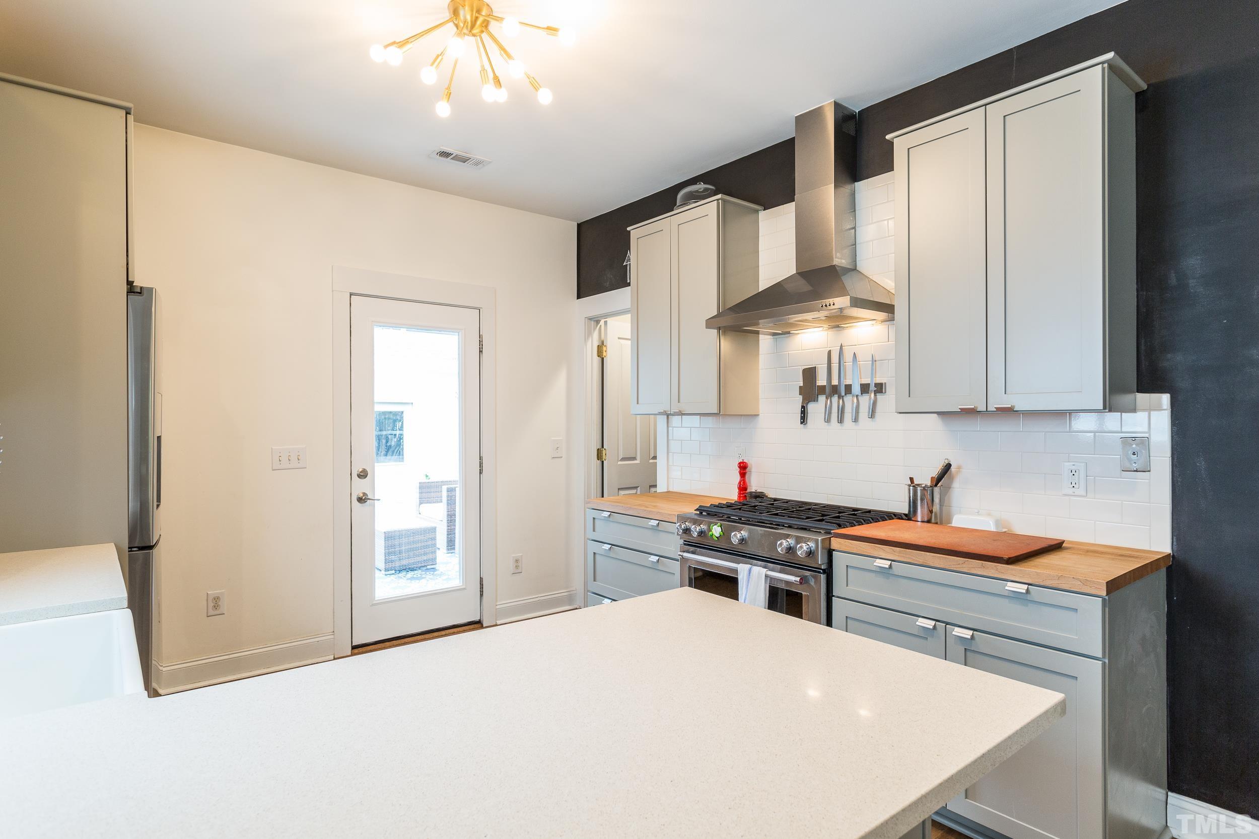 2116 Dunn Road Raleigh, NC 27614 - Photo 10 of 26 a kitchen with stainless steel appliances a sink stove and refrigerator