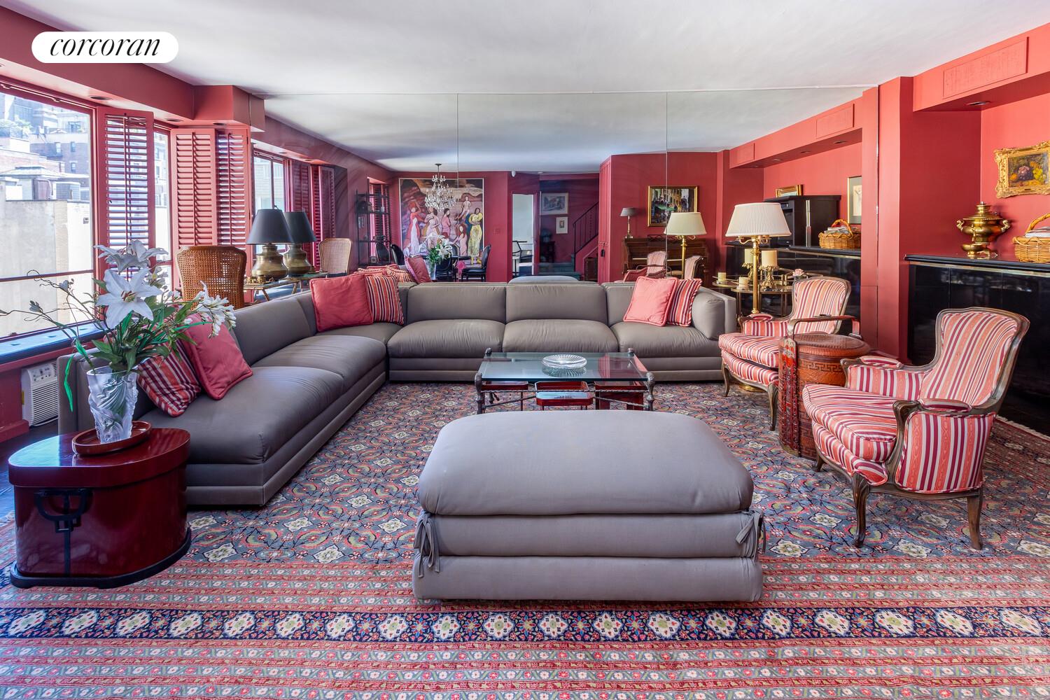 a living room with furniture a rug and a large window