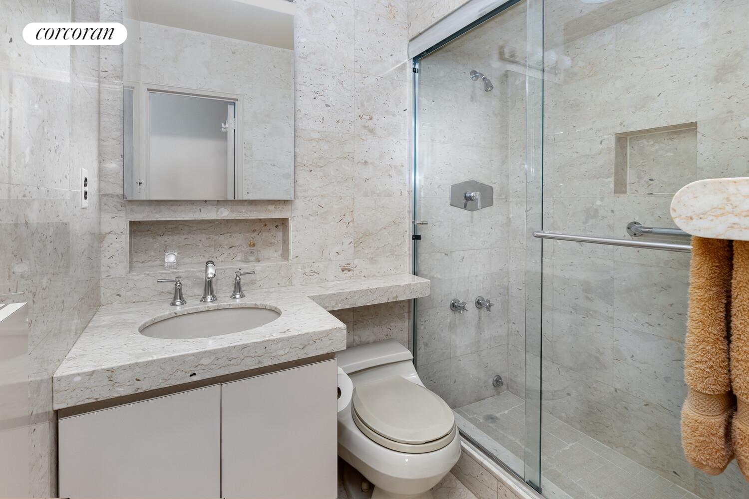 1050 5th Avenue, Unit 11/12A Manhattan, NY 10028 - Photo 6 of 13 a bathroom with a sink toilet and shower