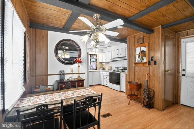 a view of a hallway with dining area a chandelier and entryway