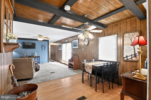 a bedroom with a bed and a chandelier with a flat tv screen