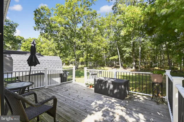 a view of a chair and table on the wooden deck