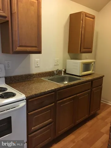 a kitchen with granite countertop cabinets and stove