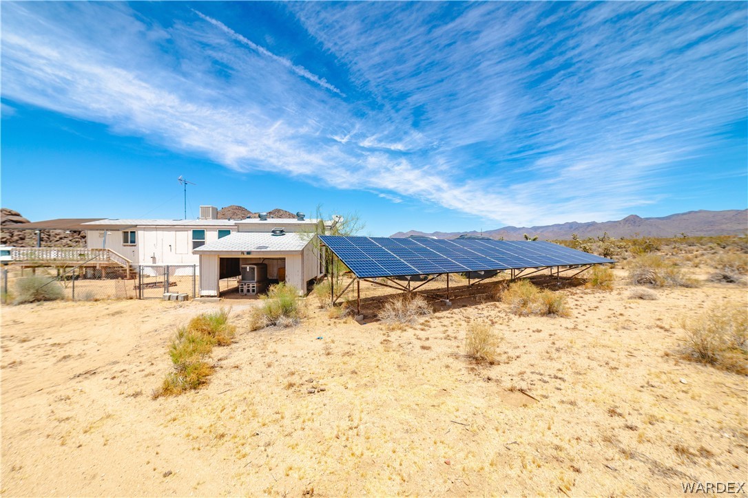 16435 South Wyatt Earp Road Yucca, AZ 86438 - Photo 28 of 57 Ground-mounted solar array with desert landscaping