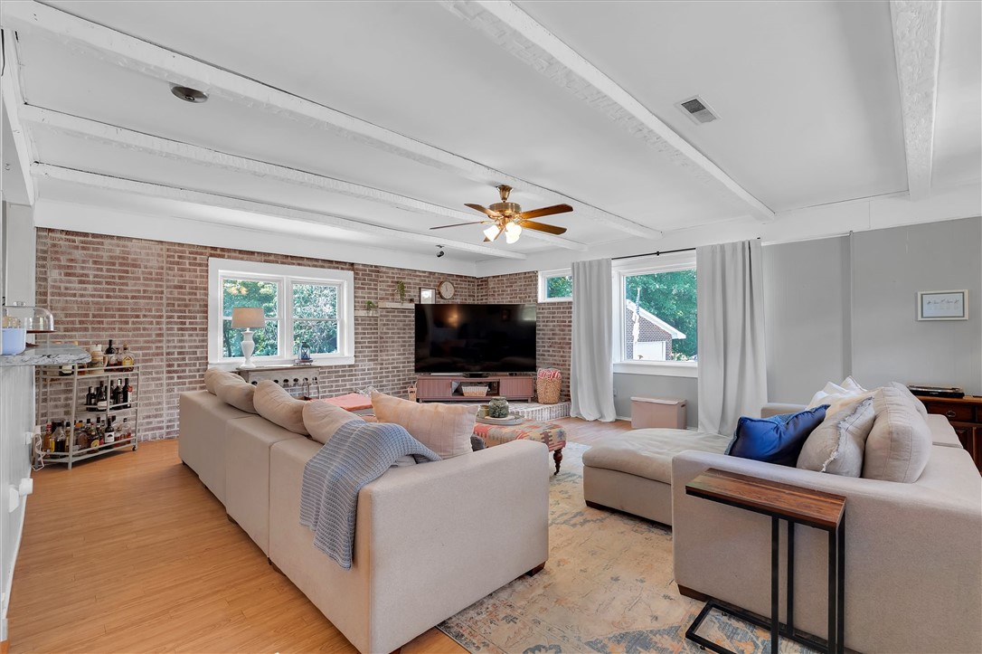 1815 Pearman Dairy Road Anderson, SC 29625 - Photo 9 of 35 Exposed brick walls and beamed ceilings create a captivating focal point in this welcoming gathering space.