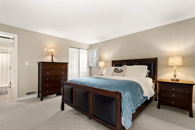 a bedroom with a bed and a tv