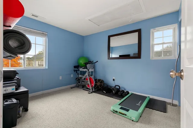 a room with gym equipment and a window