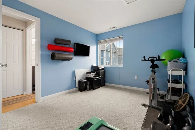 a living room with furniture a flat screen tv and a window