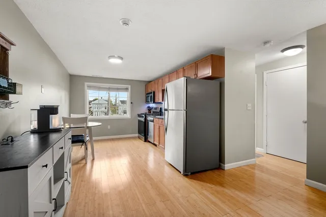 a kitchen with stainless steel appliances granite countertop a refrigerator stove and sink