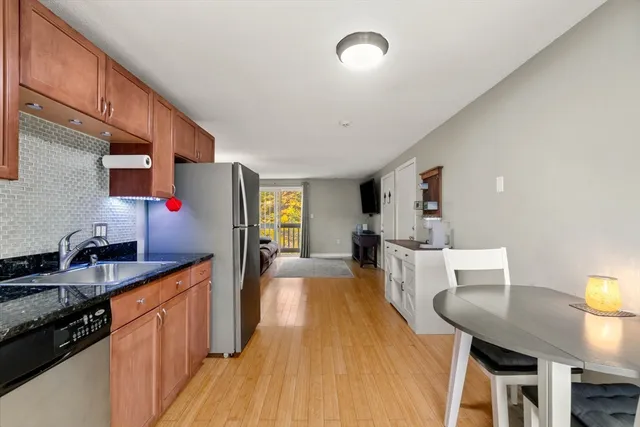 a kitchen with counter top space a sink appliances and cabinets