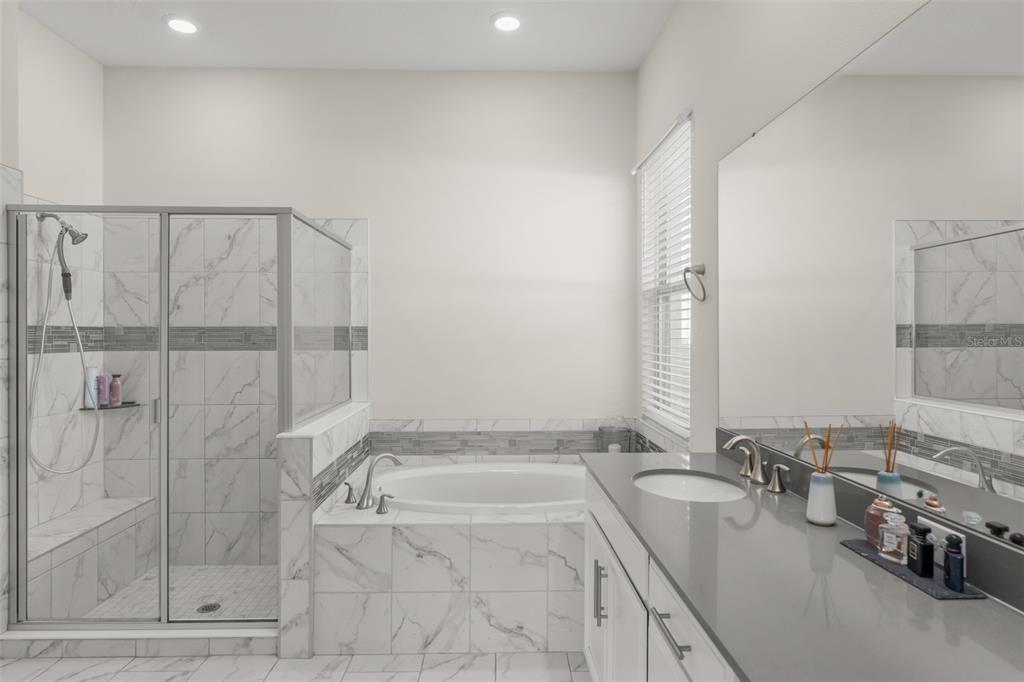 375 Dancing Water Drive Winter Springs, FL 32708 - Photo 25 of 73 a bathroom with a granite countertop sink a mirror and shower