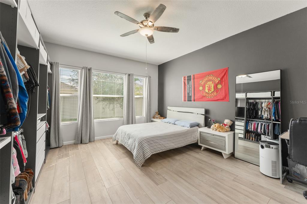 375 Dancing Water Drive Winter Springs, FL 32708 - Photo 29 of 73 a bedroom with a bed bookshelf and a window