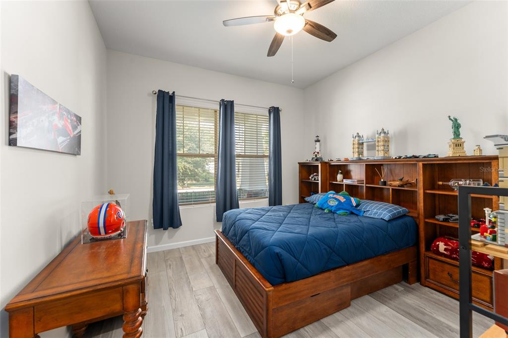 375 Dancing Water Drive Winter Springs, FL 32708 - Photo 34 of 73 a bedroom with a bed and wooden floor