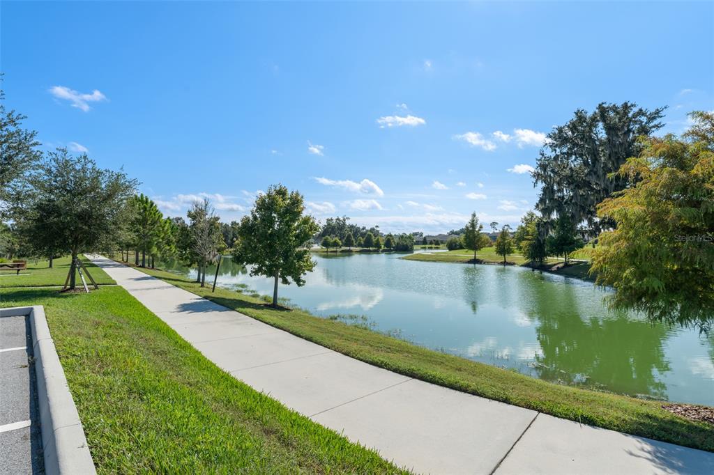 375 Dancing Water Drive Winter Springs, FL 32708 - Photo 59 of 73 a view of a lake with a garden