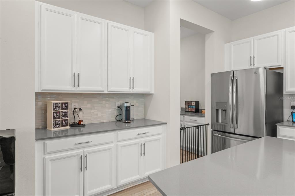 375 Dancing Water Drive Winter Springs, FL 32708 - Photo 10 of 73 a kitchen with stainless steel appliances a refrigerator sink and cabinets