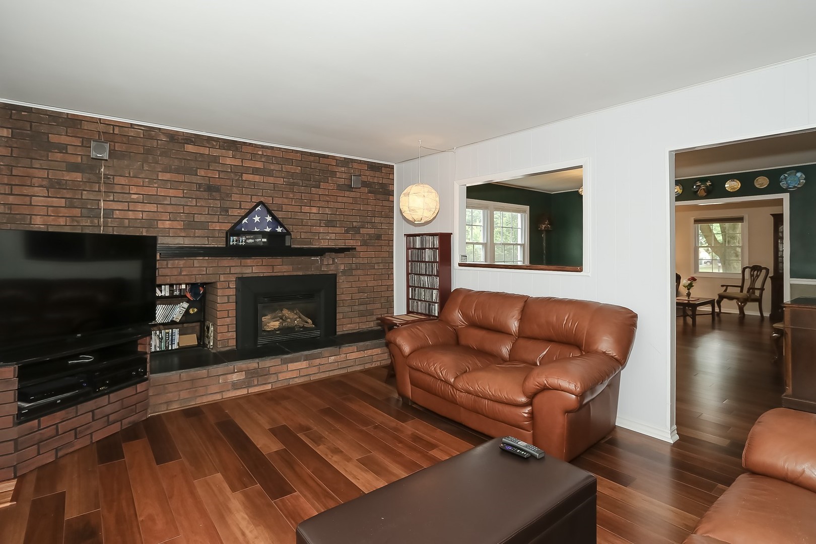 136 Weidner Road Buffalo Grove, IL 60089 - Photo 14 of 41 a living room with furniture a flat screen tv and a fireplace
