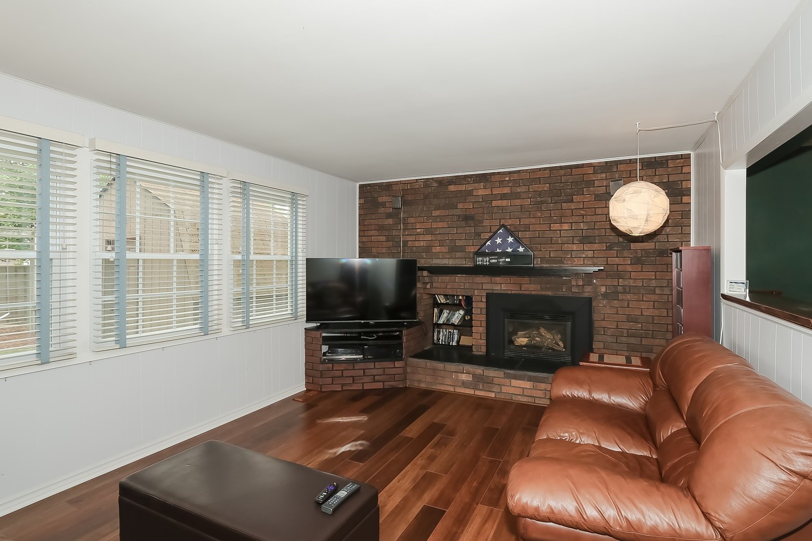 136 Weidner Road Buffalo Grove, IL 60089 - Photo 16 of 41 a living room with furniture a fireplace and a flat screen tv