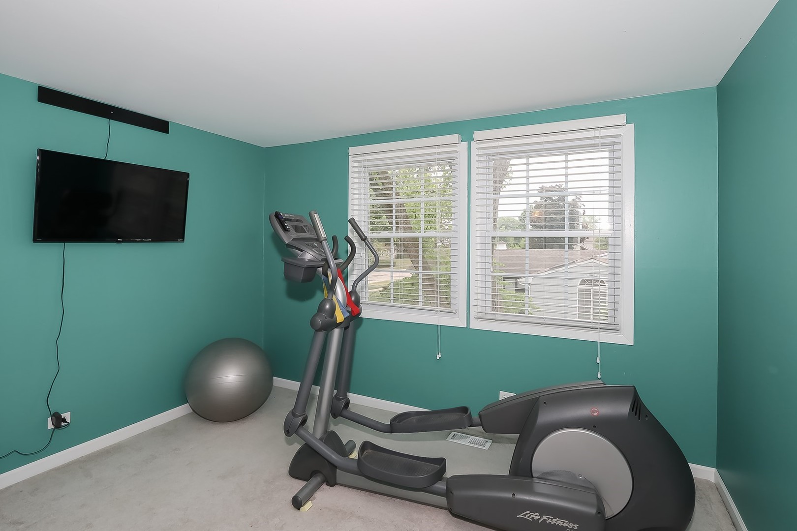 136 Weidner Road Buffalo Grove, IL 60089 - Photo 23 of 41 a room with furniture and a flat screen tv