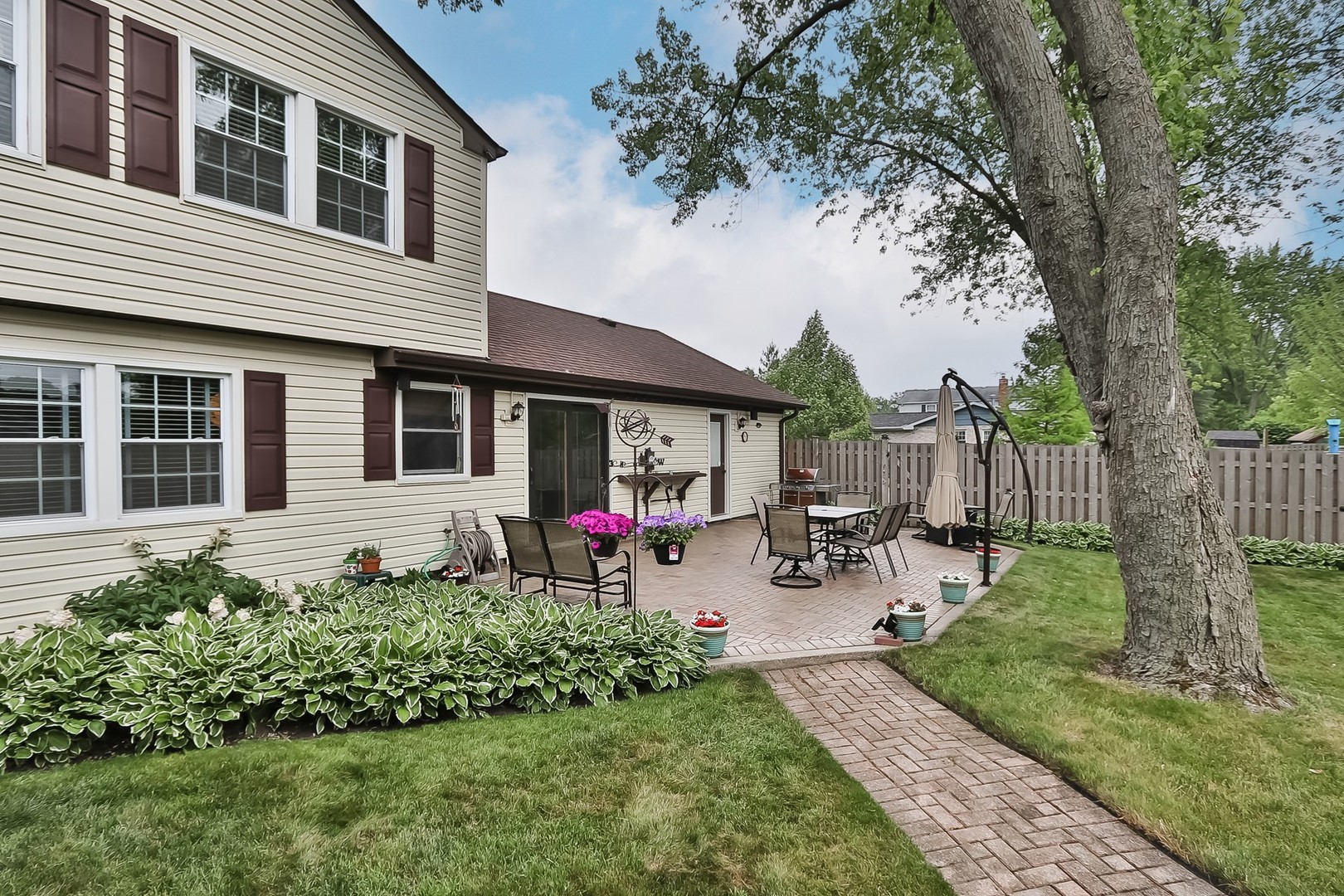 136 Weidner Road Buffalo Grove, IL 60089 - Photo 32 of 41 a view of a house with backyard sitting area and garden