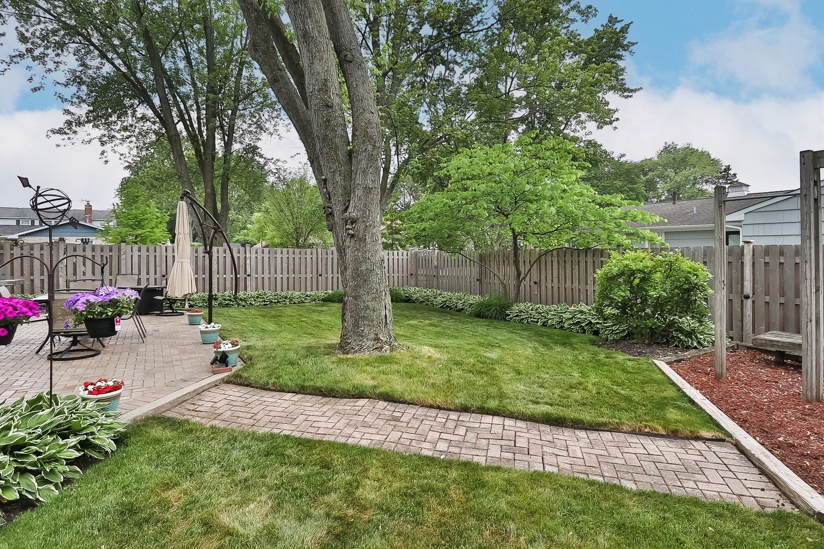 136 Weidner Road Buffalo Grove, IL 60089 - Photo 34 of 41 a view of a backyard with table and chairs and a large tree
