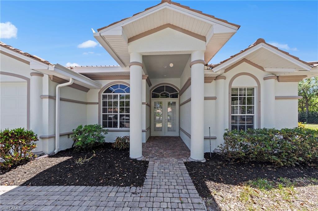 9623 Springlake Circle Estero, FL 33928 - Photo 4 of 47 a front view of a house with garden