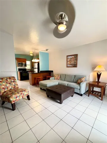 a bedroom with a bed and chandelier