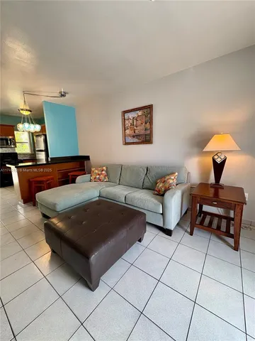 a living room with furniture and a lamp