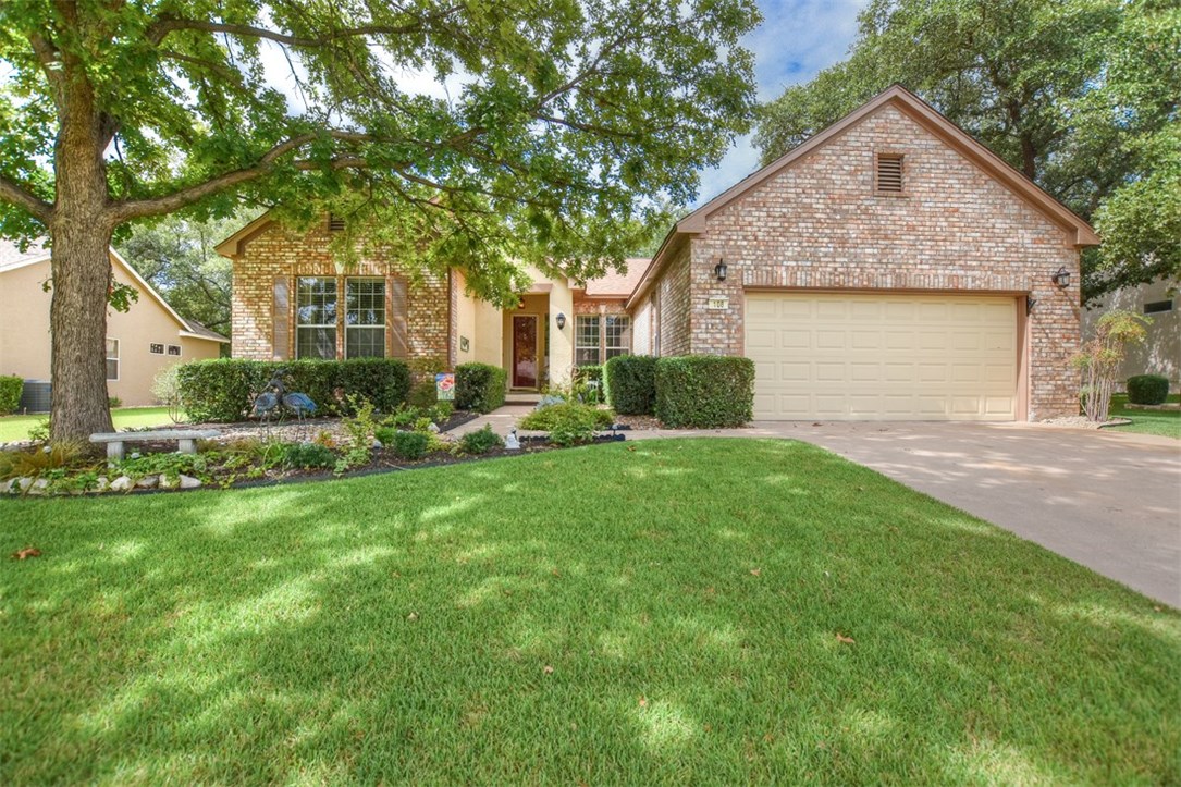 Welcome Home!  Beautiful trees abound in this area of Sun City.  Very inviting entry with a large flower bed under the tree and pretty shrubbery surrounding the front porch...