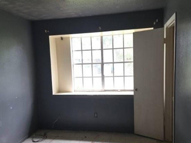 4806 Grapevine Street Houston, TX 77045 - Photo 4 of 13 a view of an empty room with a window