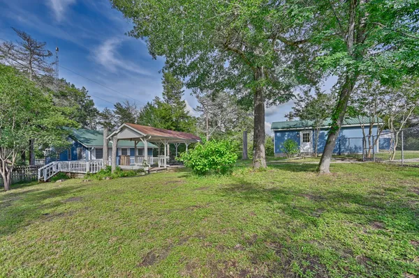 a view of a house with a yard porch and sitting area